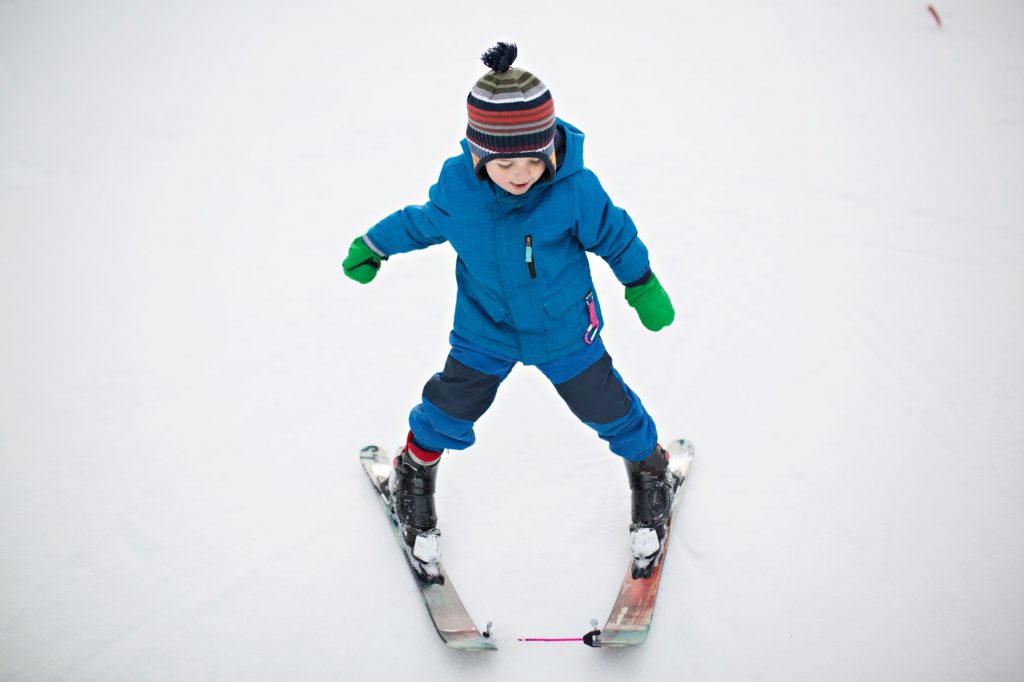 young children skiing while on holiday